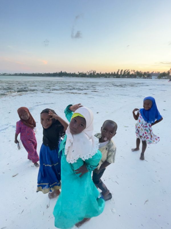 traveling on your own in Zanzibar has good things like meeting children on a beach.